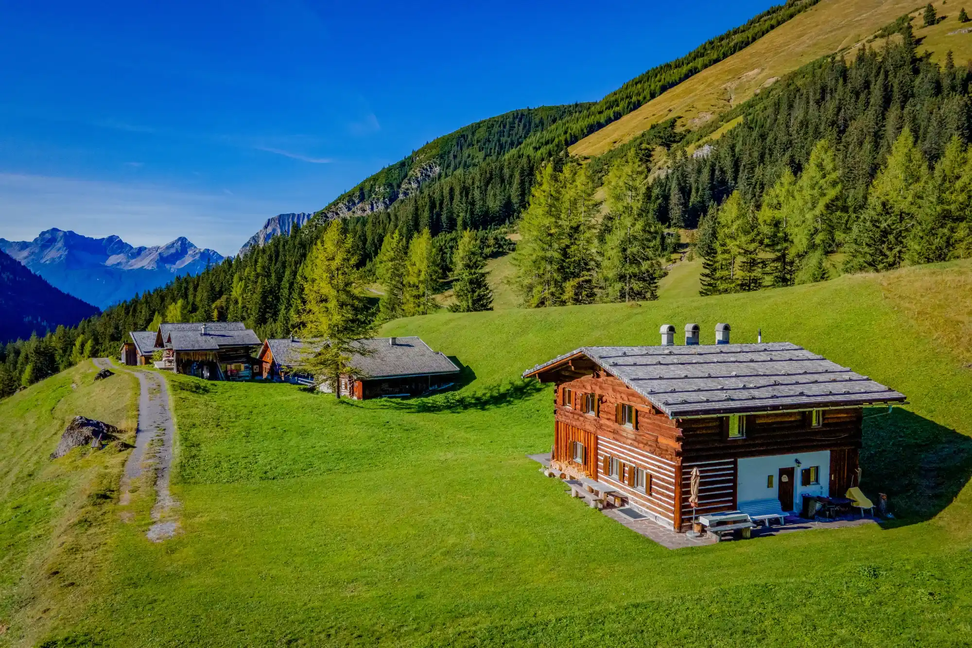 Alpine pastures and wooden huts in the summer mountain landscape of the Lechtal